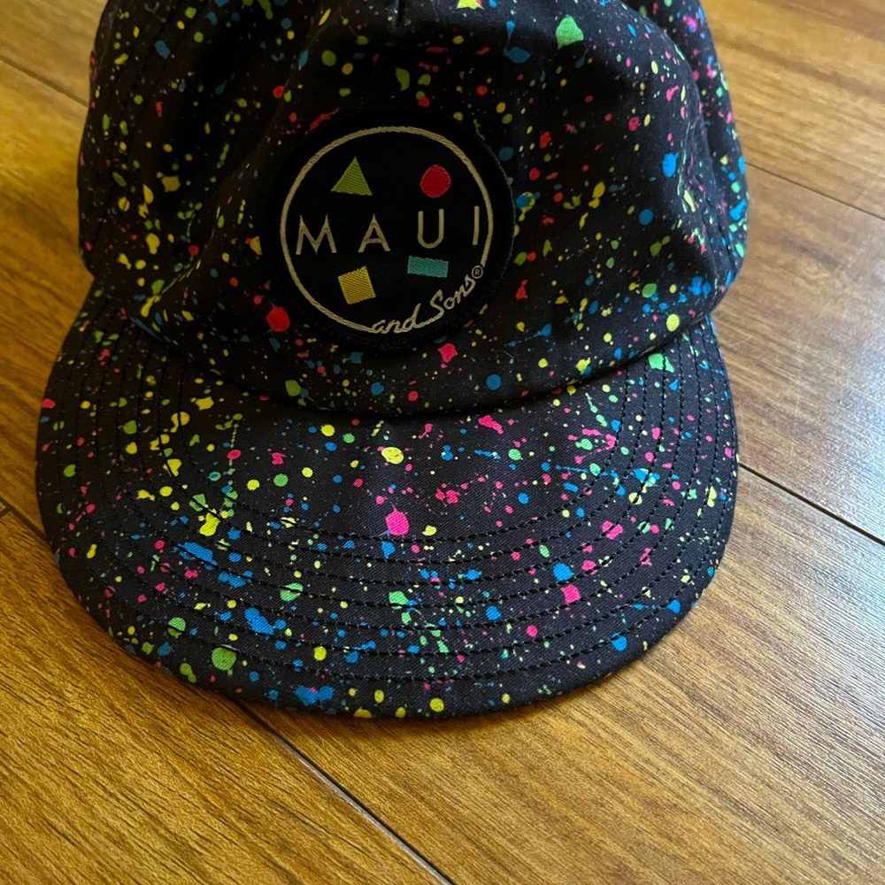 Fun hat neon splattered black background